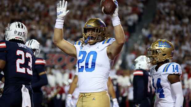Nov 4, 2023; Tucson, Arizona, USA; UCLA Bruins running back Carsen Ryan #20 celebrates a touchdown against the Arizona Wildcats during the first half at Arizona Stadium. Mandatory Credit: Zachary BonDurant-USA TODAY Sports